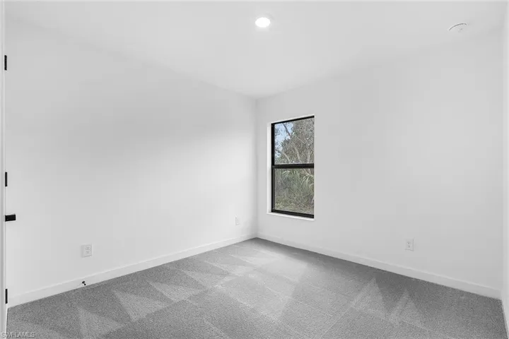 Empty room with carpet floors and recessed lighting
