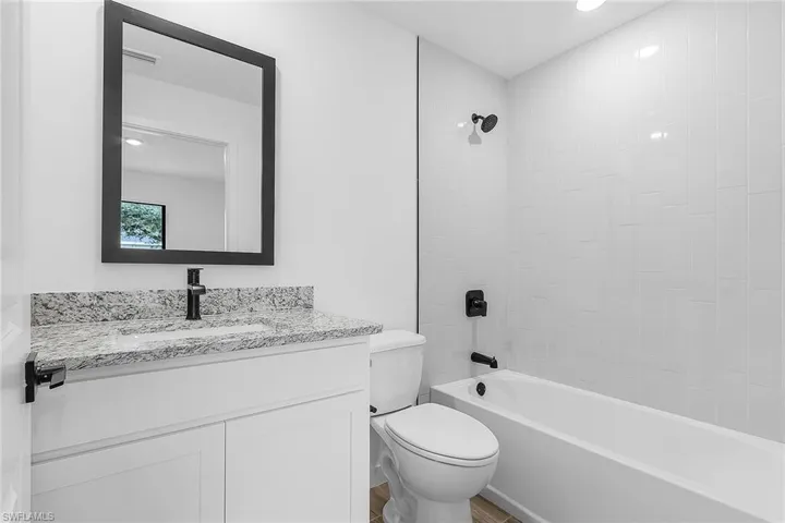 Bathroom featuring vanity and shower / tub combination