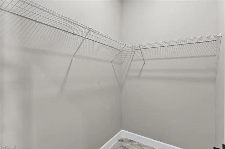 Spacious closet with stone finish floors