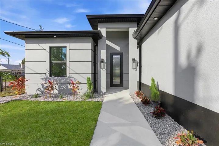 Doorway to property featuring stucco siding