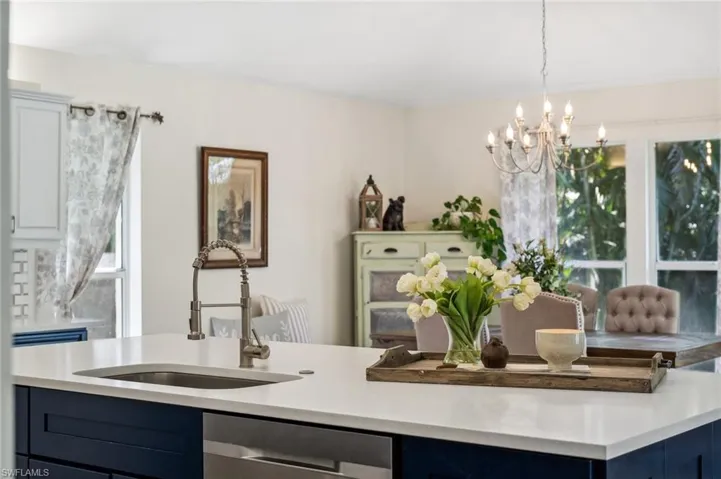 Kitchen with dishwasher, light countertops, and a sink