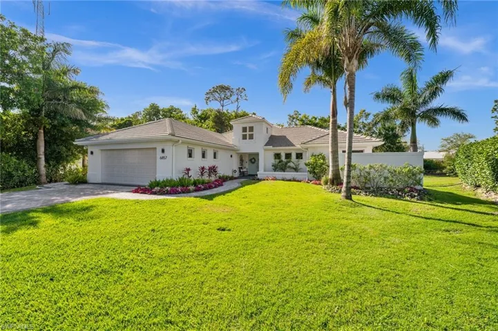 Mediterranean / spanish-style house featuring driveway, a tile roof, an attached garage, a front yard, and stucco siding