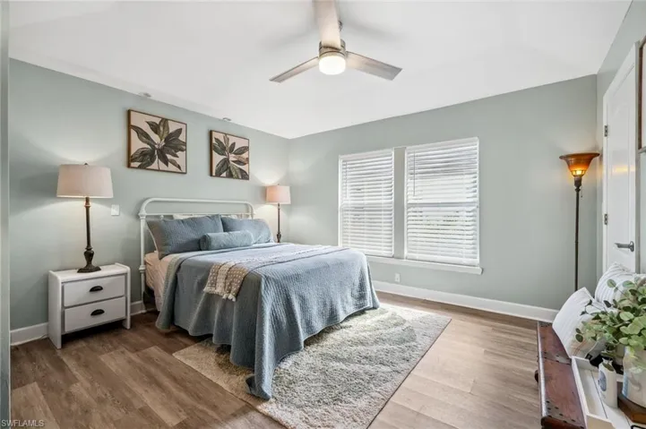 Bedroom featuring ceiling fan, baseboards, and wood finished floors
