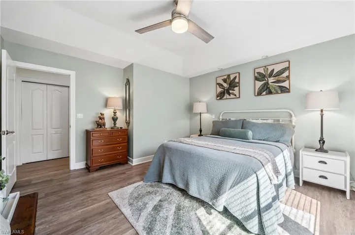 Bedroom featuring ceiling fan, baseboards, and wood finished floors