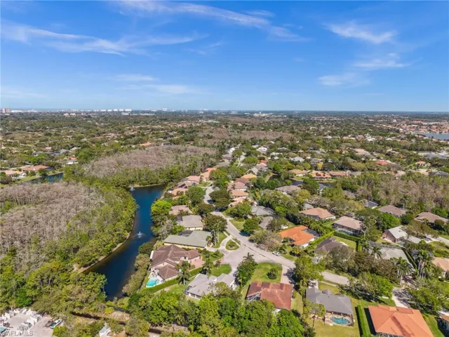 Birds eye view of property featuring a water view and a residential view