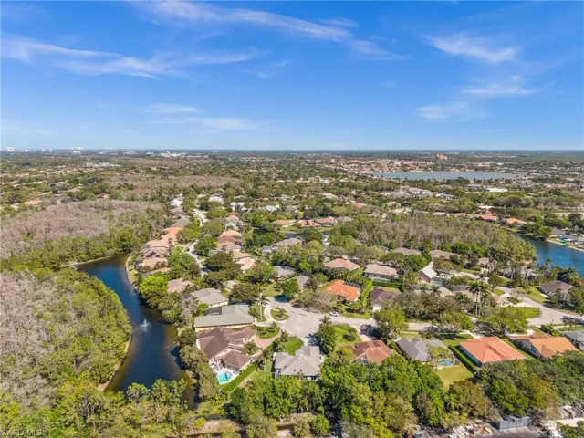 Birds eye view of property featuring a water view and a residential view