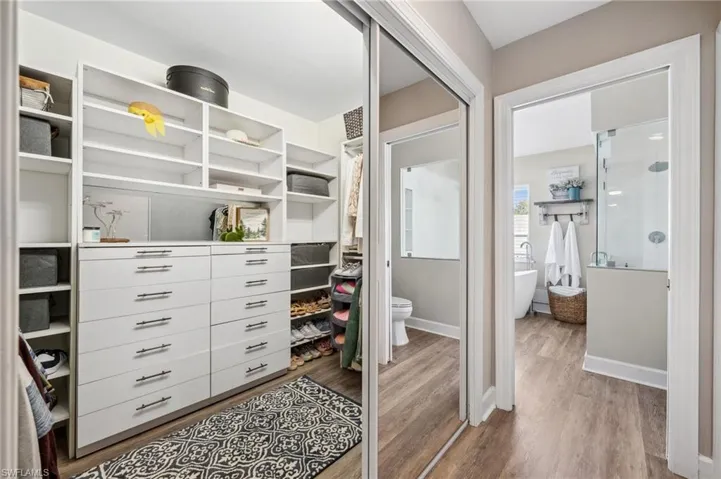 Spacious closet with light wood finished floors