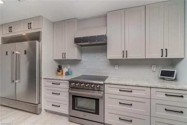 Kitchen with custom cabinets, Cambria counters, and high end appliances