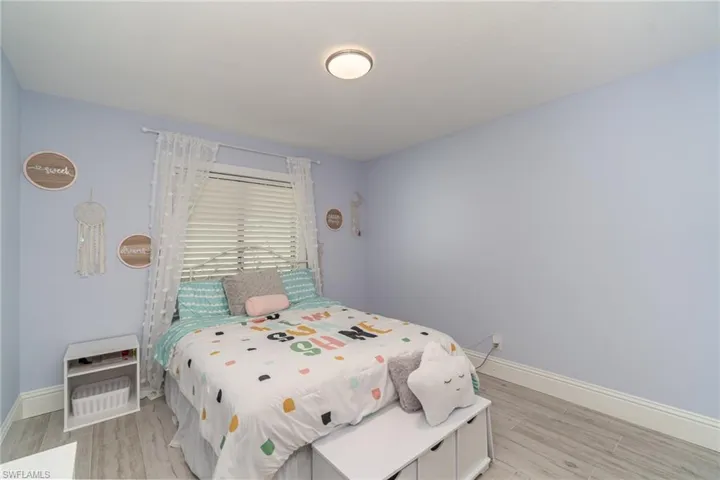 Bedroom featuring tile plank flooring
