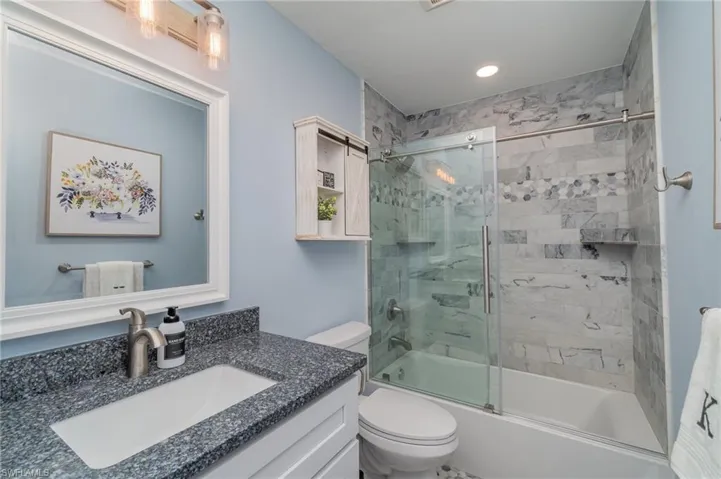 Full bathroom with enclosed tub / shower  toilet, and vanity