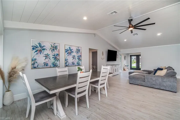 Dining area with ceiling fan and tile plank floors