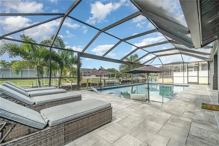 View of swimming pool, screened picture window cage & 360 spa