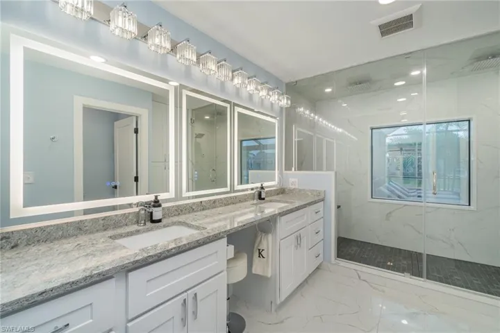 Dual sinks, seating/makeup area between sinks, quartz, marble flooring, linen closet, custom steam shower, two rain heads, handheld, steams up to 120 degrees