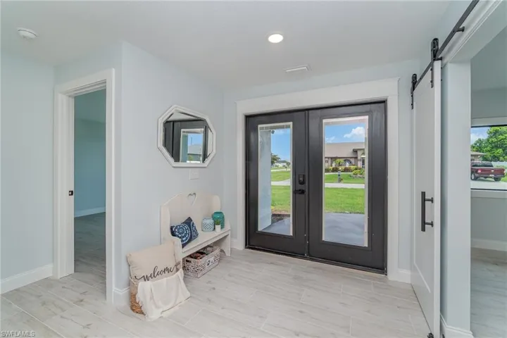 Entrance foyer featuring a barn door and french doors