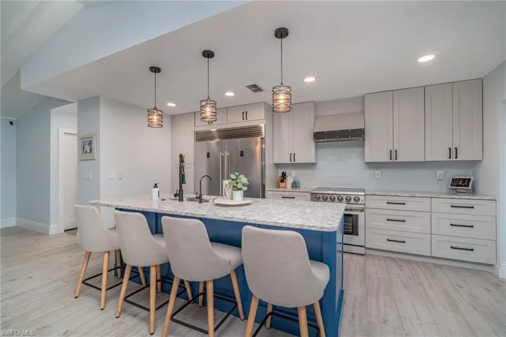 Kitchen with professional grade appliances, center Island & pendant lighting.