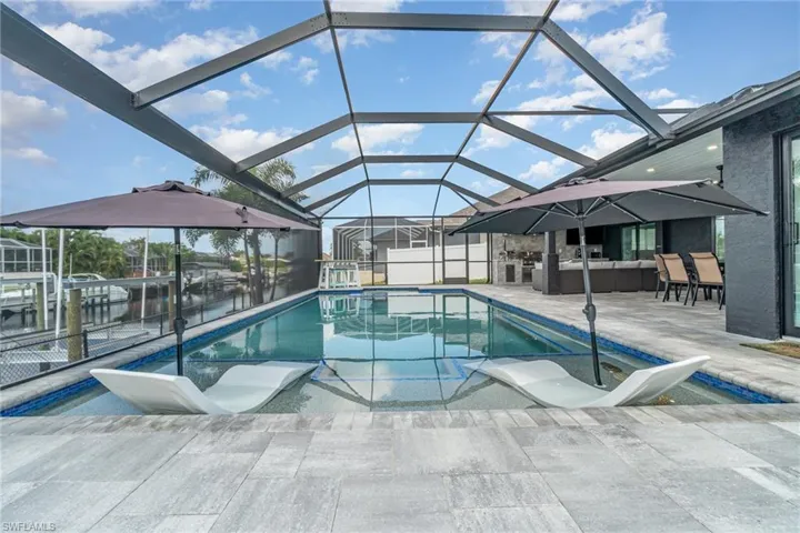 View of swimming pool with sun pads