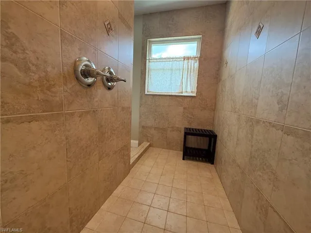 Bathroom with a tile shower and heating unit