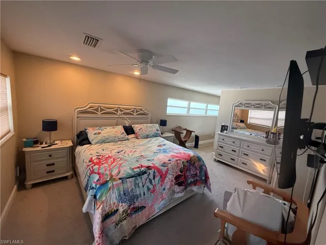 Carpeted bedroom featuring ceiling fan
