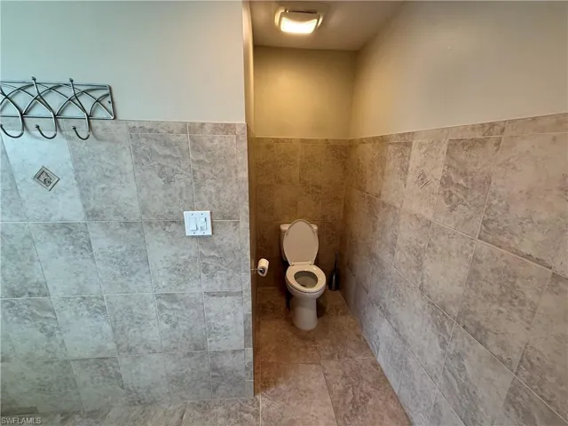 Bathroom with tile walls and wainscoting
