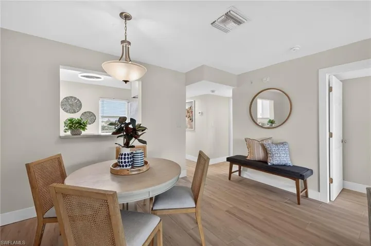 Dining room with tile floors and chandelier