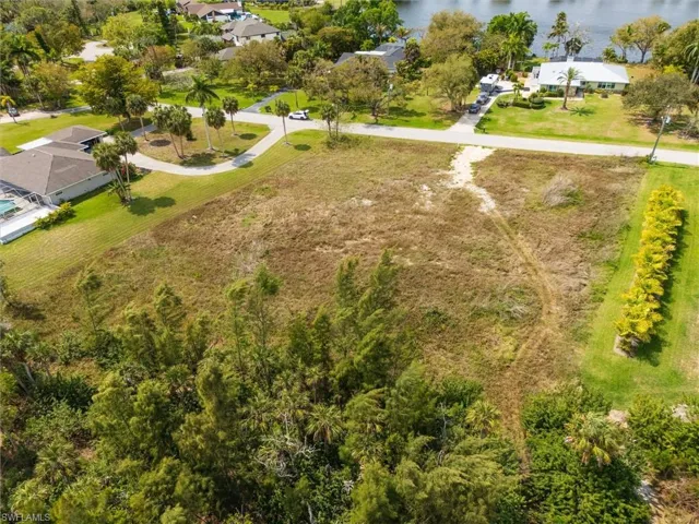 Aerial view of residential area featuring a nearby body of water