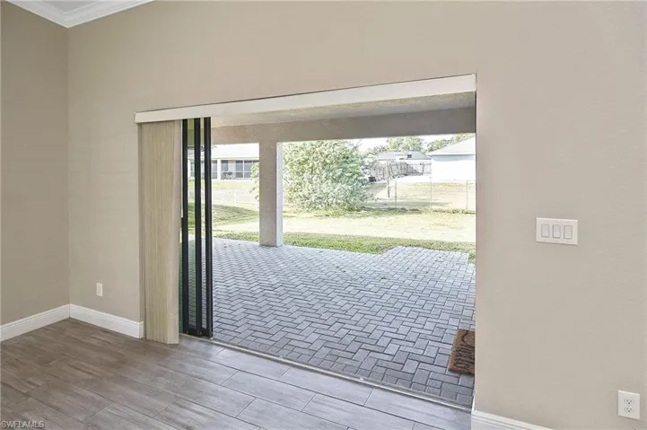 Entryway with hardwood / wood-style flooring, a healthy amount of sunlight, and ornamental molding