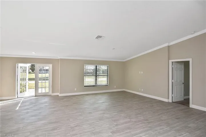 Spare room featuring light hardwood / wood-style floors and ornamental molding