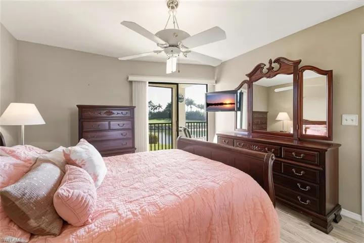 Bedroom with access to outside, ceiling fan, and light wood-type flooring