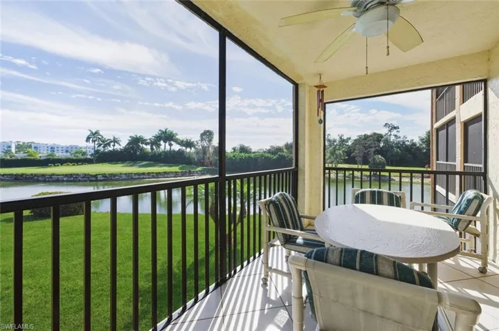 Sunroom / solarium featuring a water view and tile patterned floors