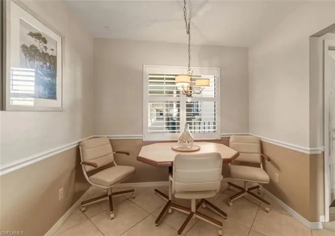 Dining space featuring light tile patterned floors