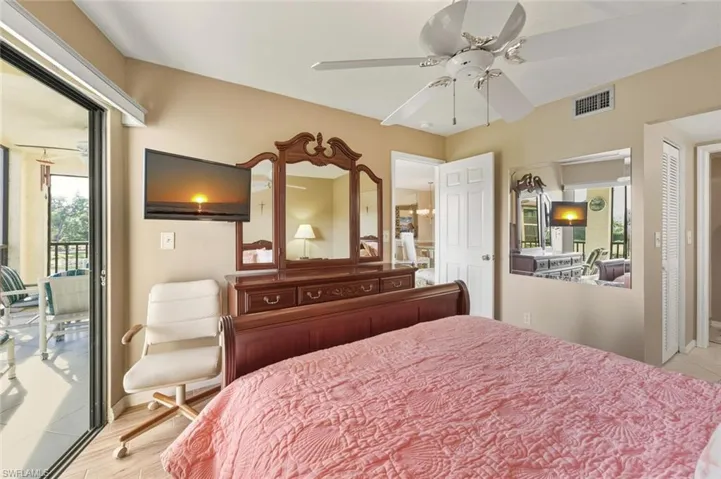 Bedroom with access to exterior and a ceiling fan