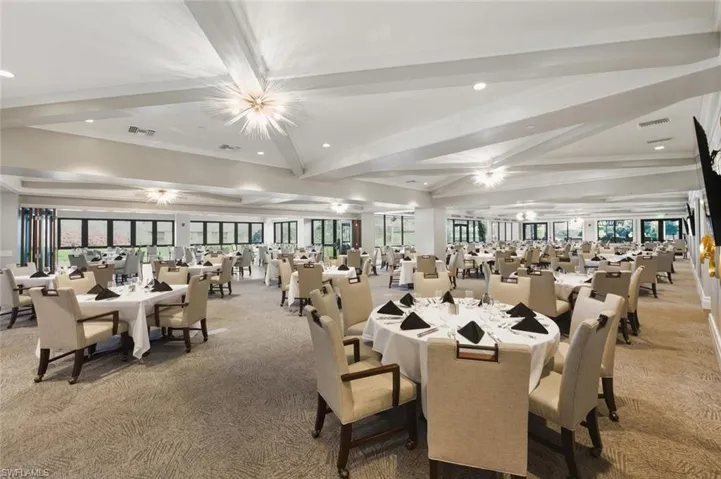 Dining room featuring carpet, recessed lighting, healthy amount of natural light, beam ceiling, and crown molding