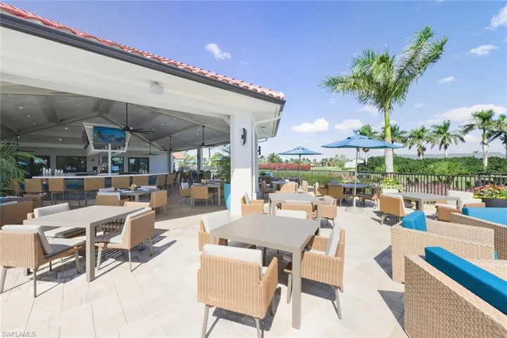View of patio featuring outdoor dining area, ceiling fan, and an outdoor hangout area