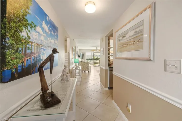 Hall with light tile patterned floors and baseboards
