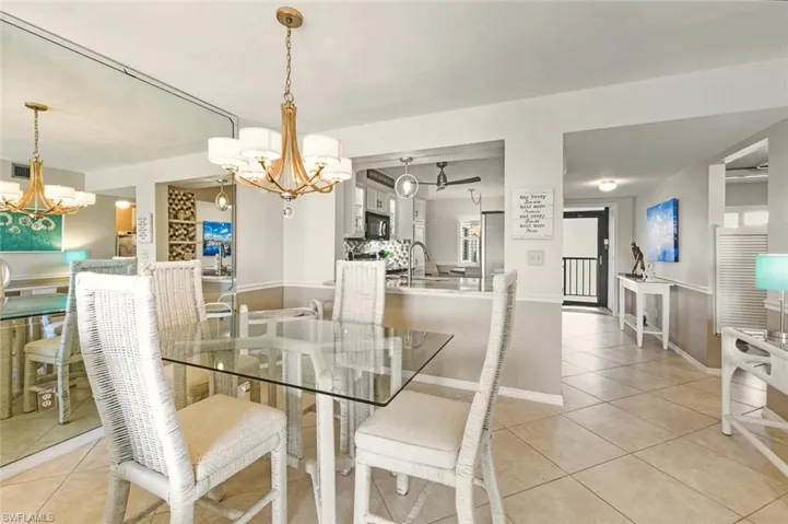 Dining space with a chandelier and light tile patterned flooring