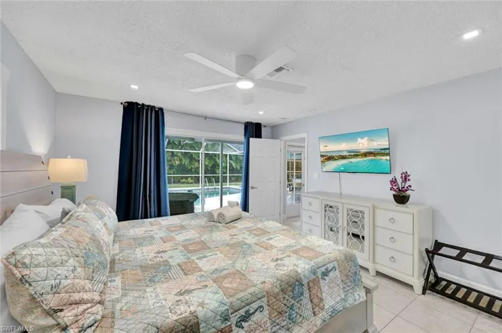 Bedroom with access to exterior, ceiling fan, light tile patterned floors, a textured ceiling, and recessed lighting