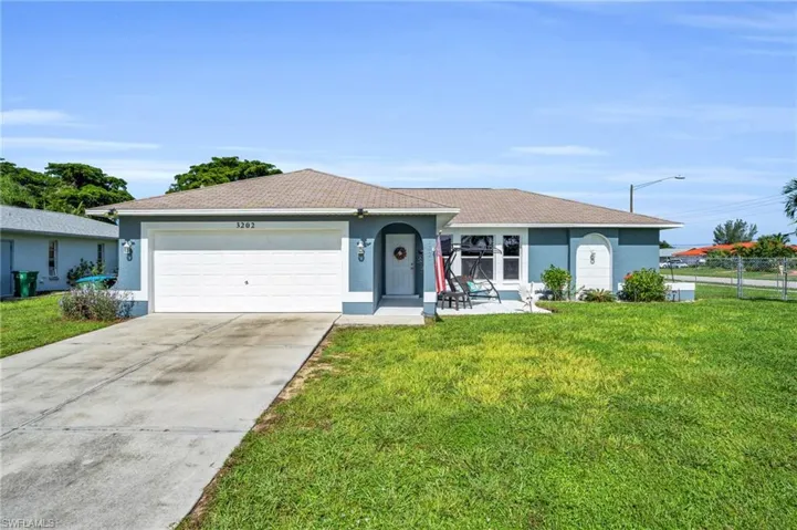 Ranch-style house with a garage and a front yard