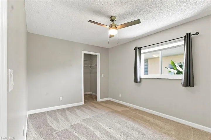 Neutral-toned walls complement patterned carpeting