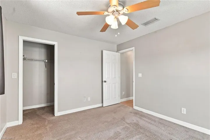 Wall-to-wall carpeting with light gray wall finishes