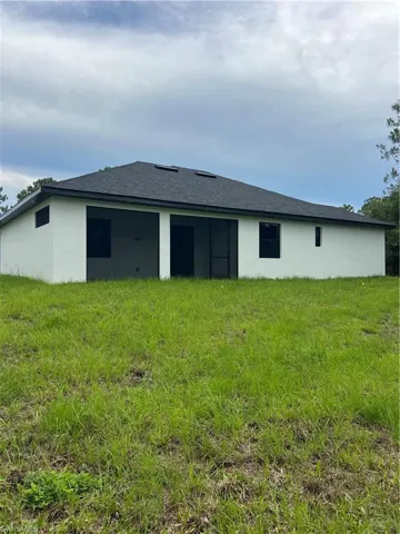 Rear view of house featuring stucco siding