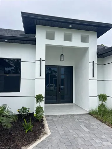 Property entrance featuring french doors and stucco siding