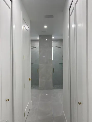 Full bathroom featuring a marble finish shower, marble finish flooring, and recessed lighting