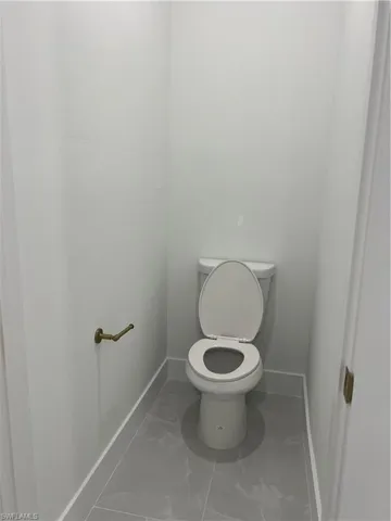 Bathroom with baseboards and marble finish flooring