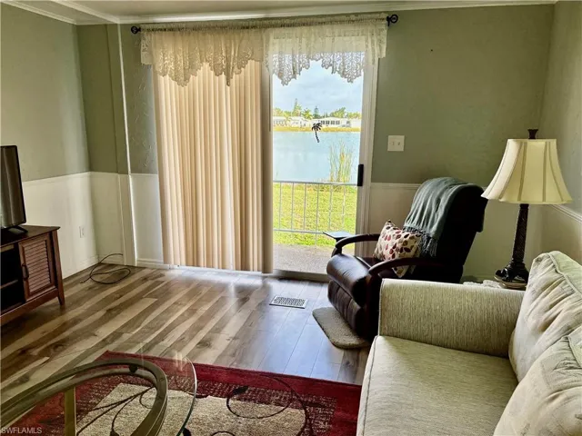 Living room with a water view and hardwood / wood-style flooring