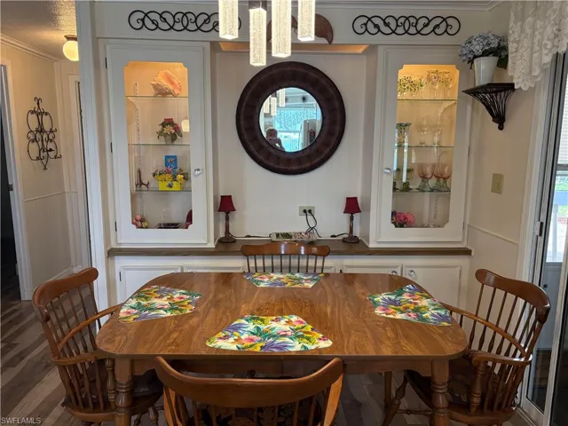 Dining space featuring ornamental molding and hardwood / wood-style floors