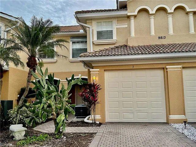 Stucco exterior featuring a tiled roof and arched architectural details
