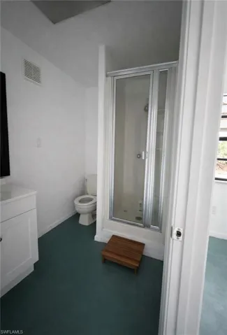 Bathroom with vanity and a stall shower