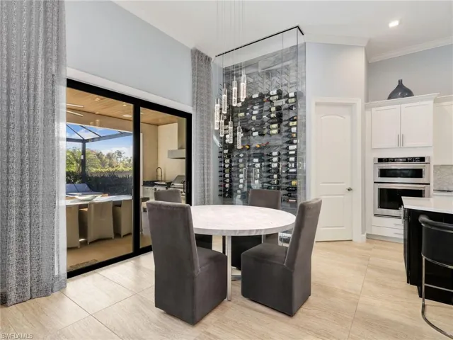 Eat-In Kitchen With Custom Tile & Glass Wine Wall & Sliders Leading to Custom Outdoor Kitchen