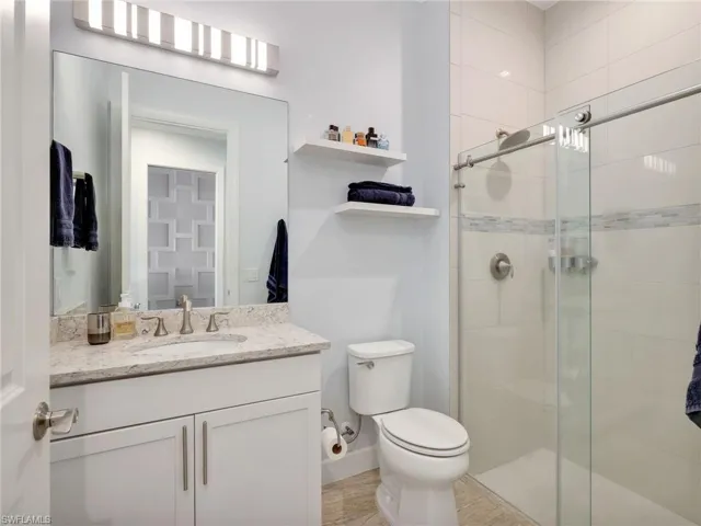 Front Hallway Bathroom with Floor To Ceiling Shower Tile and Glass Enclosure