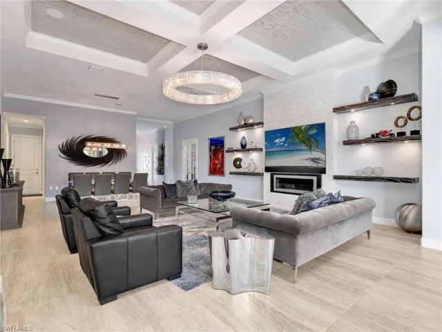 Great Room, Coffered Ceiling With Custom Wall Coverings, WHOLE-HOME SONOS AUDIO with in-ceiling speakers & soundbars, and Wi-Fi extenders, Custom Stone Fireplace, Custom Shelving With Lighting, Restoration Hardware Chandeliers, and Dining Area